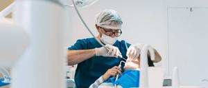Ein Zahnarzt und vor ihm ein Patient.