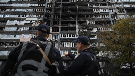 Ukrainische Polizisten stehen vor einem Wohnhaus, das bei massiven russischen Drohnen- und Raketenangriffen auf Kiew am 10. Oktober 2025 beschädigt wurde.