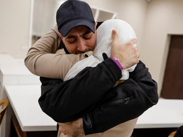 A freed Palestinian is hugged by a relative after he was released from an Israeli jail as part of a hostages-prisoners swap and a ceasefire deal in Gaza between Hamas and Israel, in Ramallah, in the Israeli-occupied West Bank, October 13, 2025. REUTERS/Ammar Awad