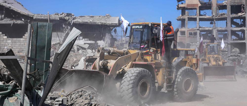 Bulldozer der Stadtverwaltung von Gaza räumen Trümmer von Gebäuden von den Straßen in Gaza-Stadt.