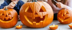 Kinder beim Kürbisschnitzen.