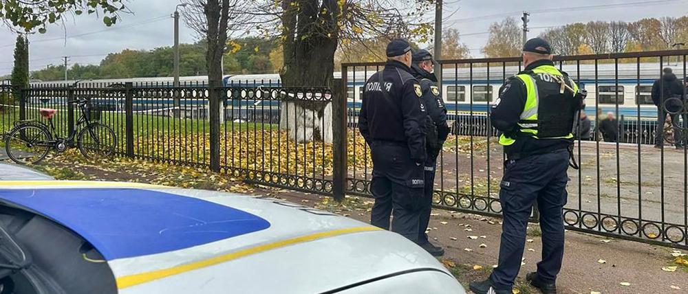 Polizeibeamte der Ukraine stehen an einem Zaun vor dem Bahnhof in Ovruch im Norden des Landes.