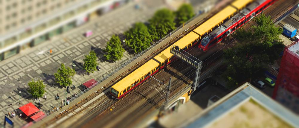 Aerial view of the S-Bahn tracks rapid train and tram train at the Alexanderplatz public square in Berlin. with tilt-shift effect.