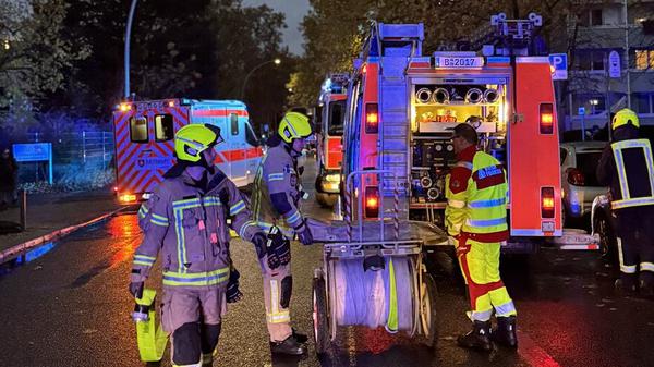 Einsatzkräfte am Löschfahrzeug vor dem Haus in der Habersaathstraße.