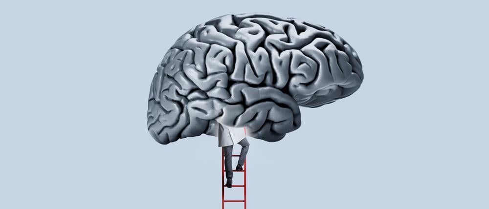 Ein Arzt klettert per Leiter in ein Gehirn (Illustration).