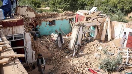 Überlebende des Erdbebens in Afghanistan durchsuchen am 3. November 2025 die Trümmer eines zerstörten Hauses in einem Dorf in Tashqurghan im Bezirk Khulm in der Provinz Samangan.