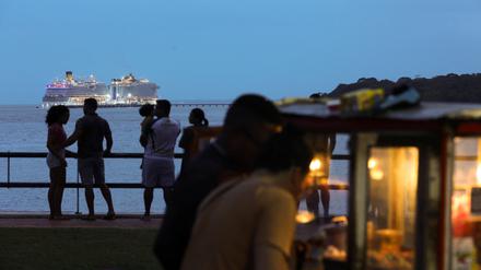 Menschen flanieren am Brasilia Beach in Belém. Im Hintergrund steuert ein Schiff den neuen Hafen der Stadt an.