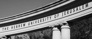 JERUSALEM, ISRAEL - FEBRUARY 19, 2014: The Hebrew University of Jerusalem sign on the arch of the amphitheater at Mount Scopus (Har Ha-Tzofim) campus. Mount Scopus campus was inaugurated in 1925. Black and white photo.
