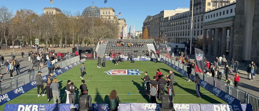 06.11.2025, Berlin: Am Platz vor dem Brandenburger Tor ist Kunstrasen ausgerollt - hier können sich Fans im Flag Football (eine Variante des American Football) ausprobieren. Am 09.11.2025 treffen die Atlanta Falcons beim Berlin Game auf die Indianapolis Colts. Foto: Jordan Raza/dpa +++ dpa-Bildfunk +++