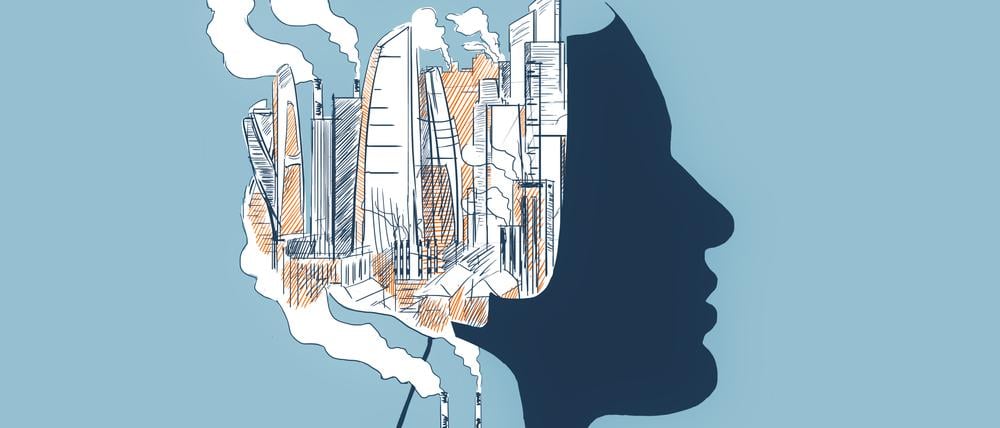 Eine Fabrik sondert vor einem Kopf Feinstaub ab (Illustration).