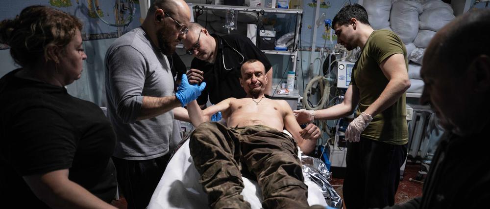 11.11.2025, Ukraine, Gebiet Donezk: Auf diesem Foto leisten Sanitäter dem verwundeten Soldaten Oleg Solontschak an einem Stabilisierungspunkt in der Nähe von Kostjantyniwka in der Region Donezk erste Hilfe. 