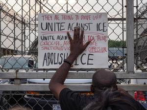 Protestors Rally Outside Delaney Hall ICE Detention Facility In Newark, NJ - 13th Jun 2025 A protestor holds up a sign, reading Unite Against I.C.E , against the gate of Delaney Hall Detention Facility during a demonstration. Demonstrators gathered outside of the facility, where four detainees escaped after allegedly breaking through a wall, to voice opposition to increased raids against migrants. Newark United States Copyright: xDerekxFrenchx/xSOPAxImagesx NJ_DelaneyHall13JUN25_0003