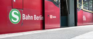 Eine Berliner S-Bahn steht mit geöffneten Türen an einem Bahnsteig. (Archivbild)