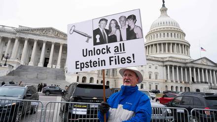 WASHINGTON, DC - NOVEMBER 18: A protester holds a placard after the House voted 427-1 to approve the Epstein Files Transparency Act and the release of documents and files at the U.S. Capitol on November 18, 2025 in Washington, DC. The legislation instructs the U.S. Department of Justice to release all files related to the late accused sex trafficker Jeffrey Epstein. It now goes to the Senate for a vote before President Donald Trump can sign it into law.   Roberto Schmidt/Getty Images/AFP (Photo by ROBERTO SCHMIDT / GETTY IMAGES NORTH AMERICA / Getty Images via AFP)