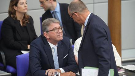 Wolfram Weimer (CDU,l), Staatsminister für Kultur und Medien, spricht mit Bundeskanzler Friedrich Merz (CDU) in der Generaldebatte in der Haushaltswoche im Bundestag. 