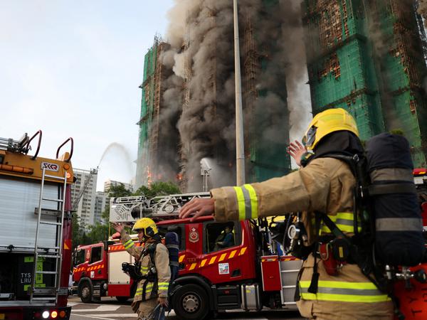Firefighters work as efforts are underway to extinguish flames engulfing bamboo scaffolding across multiple buildings at the Wang Fuk Court housing estate in Tai Po, Hong Kong, China, November 26, 2025. REUTERS/Tyrone Siu