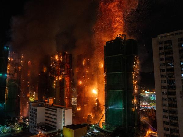 Hong Kong Building Fire Smoke and flames rise as a major fire engulfs several residential buildings at Wang Fuk Court on November 26, 2025 in Hong Kong. Serval residential building in Wang Fuk Court located in Tai Po District caught fire today, the Hong Kong Fire Department has issued the No.5 fire alarm, the fire at local time 1800 has claimed the life of one firefighter and three other people. Photo by Vernon Yuen/Nexpher Images Hong Kong