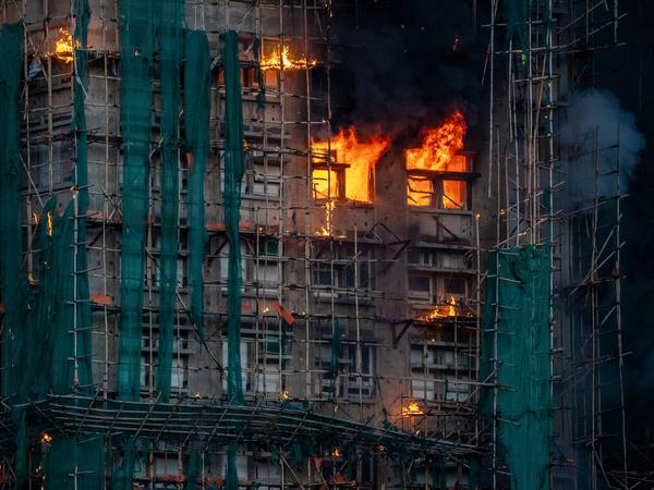 Hong Kong Building Fire A burning apartment Smoke and flames rise as a major fire engulfs several residential buildings at Wang Fuk Court on November 26, 2025 in Hong Kong. Serval residential building in Wang Fuk Court located in Tai Po District caught fire today, the Hong Kong Fire Department has issued the No.5 fire alarm, the fire at local time 1800 has claimed the life of one firefighter and three other people. Photo by Vernon Yuen/Nexpher Images Hong Kong