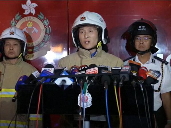 This frame grab from AFPTV video footage shows Derek Armstrong Chan, deputy director (operations) of the Hong Kong Fire Services Department, speaking to media amid ongoing operations to control a major fire at the Wang Fuk Court residential estate in Hong Kong's Tai Po district on November 26, 2025. At least 13 people have died as a result of a raging fire that tore through several high-rise blocks in a Hong Kong residential estate on November 26, a government official said. (Photo by AFPTV / AFP)