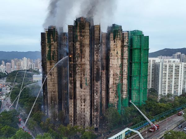 A drone view shows flames and thick smoke rising from the Wang Fuk Court housing estate during a major fire, in Tai Po, Hong Kong, China, November 27, 2025. REUTERS/Tyrone Siu