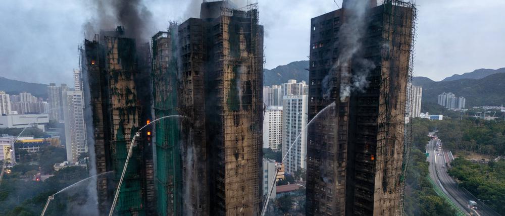 Ein Luftbild zeigt Rauch und Flammen, die aufsteigen, als am 27. November 2025 ein Großbrand mehrere Wohngebäude im Wang Fuk Court in Hongkong erfasst.