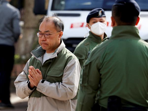 A man gestures outside the Kwong Fuk Community Hall where relatives identify family members from photos, following the deadly Wang Fuk Court housing complex fire, in Tai Po, Hong Kong, China, November 28, 2025. REUTERS/Tyrone Siu