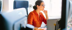 Eine Frau arbeitet an einem Computer im Büro.