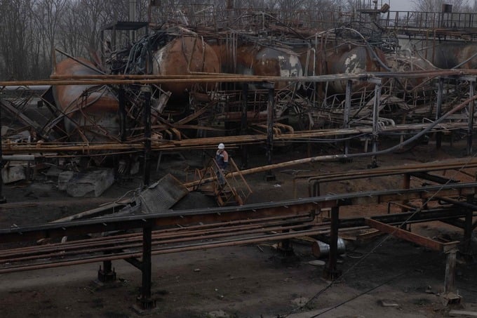 TOPSHOT - An employee walks past damaged parts of the Naftogaz gas facility, following Russian missile and drone attacks, in Ukraine, on December 2, 2025, amid the Russian invasion of Ukraine. (Photo by Roman PILIPEY / AFP)
