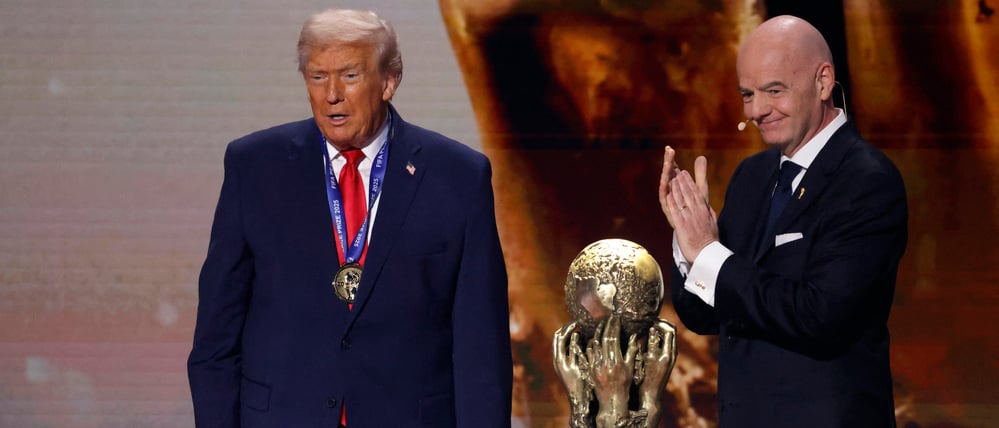 Dec 5, 2025; Washington, District of Columbia, USA; FIFA president Gianni Infantino presents United States President Donald Trump with the FIFA Peace Prize during the FIFA World Cup 2026 Final Draw at John F. Kennedy Center for the Performing Arts. Mandatory Credit: Amber Searls-Imagn Images