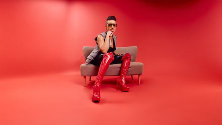 Jorge González in roten Overknees aus Leder.