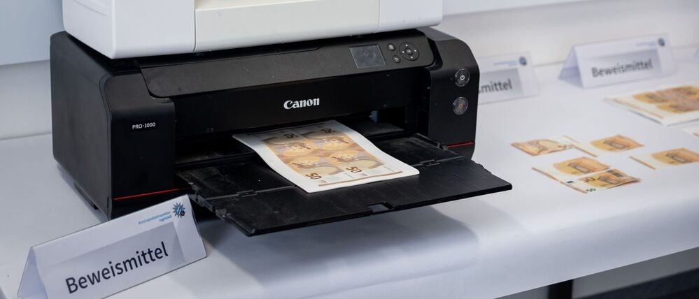 Ein von der Polizei beschlagnahmter Drucker mit gefälschten 50-Euro-Scheinen.