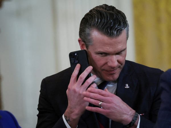 FILE PHOTO: U.S. Defense Secretary Pete Hegseth uses a phone as he attends a joint press conference of U.S. President Donald Trump and Israeli Prime Minister Benjamin Netanyahu in the East Room at the White House in Washington, U.S., February 4, 2025. REUTERS/Leah Millis/File Photo
BEST2025