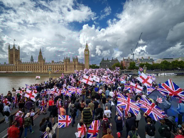 LONDON, ENGLAND - SEPTEMBER 13: Protesters wave Union Jack and St George's England flags during the "Unite The Kingdom" rally on Westminster Bridge by the Houses of Parliament on September 13, 2025 in London, England. Far-right activist Tommy Robinson (also known as Stephen Yaxley-Lennon) has invited supporters to hold a rally in central London entitled "Unite The Kingdom". The former English Defence League leader and his supporters are actively islamophobic and racist and have been behind much of the unrest seen outside hotels housing migrants this summer. Stand Up To Racism are mounting a counter-protest to today's rally. (Photo by Christopher Furlong/Getty Images)
LOW RES!!!