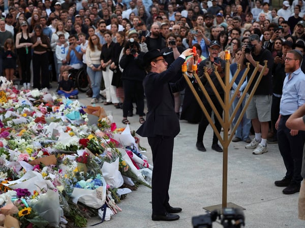 Rabbi Levi Wolff lights a menorah at Bondi Pavilion to honour the victims of a shooting during a Jewish holiday celebration at Bondi Beach, in Sydney, Australia, December 15, 2025. REUTERS/Hollie Adams