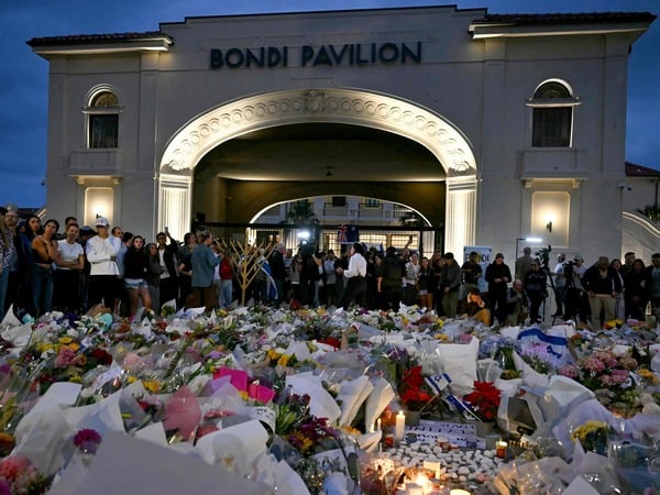 Mourners gather at a tribute at the Bondi Pavillion in memory of the victims of a shooting at Bondi Beach, in Sydney on December 15, 2025. A father and son opened fire on a Jewish festival at Australia's Bondi Beach in a shooting spree that killed 15 people, including a child, authorities said on December 15, denouncing the attack as antisemitic "terrorism". (Photo by Saeed KHAN / AFP)