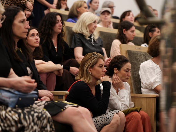 People attend a vigil at the Chabad of Bondi synagogue, after a shooting at Bondi Beach in Sydney, Australia, December 15, 2025. REUTERS/Hollie Adams