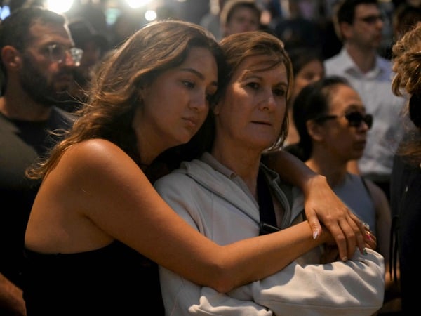 Mourners gather at a tribute at the Bondi Pavillion in memory of the victims of a shooting at Bondi Beach, in Sydney on December 15, 2025. A father and son opened fire on a Jewish festival at Australia's Bondi Beach in a shooting spree that killed 15 people, including a child, authorities said on December 15, denouncing the attack as antisemitic "terrorism". (Photo by Saeed KHAN / AFP)