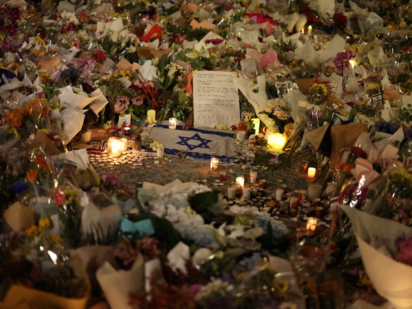 An Israeli flag sits amongst floral tributes honouring the victims of a shooting at Jewish holiday celebration on Sunday at Bondi Beach, in Sydney, Australia, December 16, 2025. REUTERS/Hollie Adams