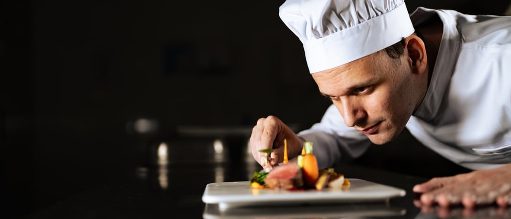 Chef decorating a plate and putting the ultimate touches
