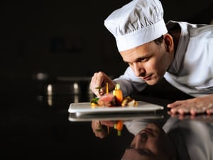 Chef decorating a plate and putting the ultimate touches