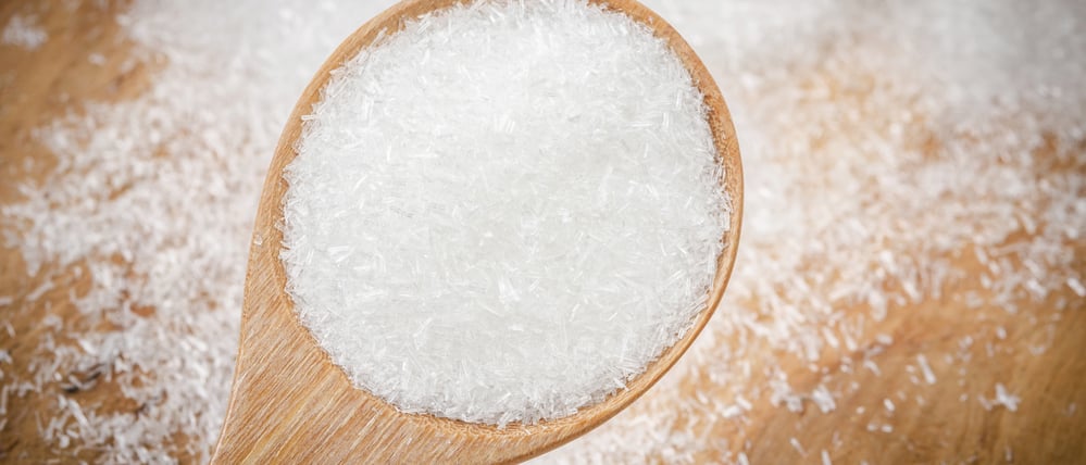 Glutamat auf einem Holzlöffel.