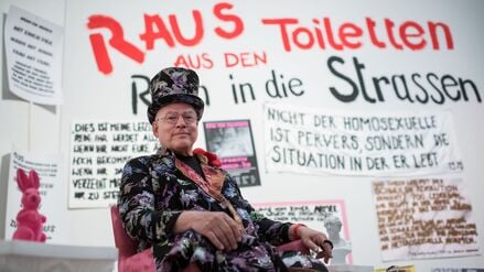 ARCHIV - 16.05.2018, Berlin: Der Künstler Rosa von Praunheim sitzt anlässlich der Pressevorbesichtigung in der Ausstellung «Abfallprodukte der Liebe» mit Werken von Elfi Mikesch, Rosa von Praunheim und Werner Schroeter (1945-2010). Der Filmemacher ist tot. Er starb im Alter von 83 Jahren, wie der Deutschen Presse-Agentur aus seinem persönlichen Umfeld bestätigt wurde. Zuvor hatten mehrere Medien berichtet. Foto: Bernd von Jutrczenka/dpa +++ dpa-Bildfunk +++