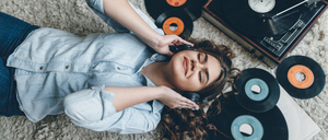 Young retro woman listening music on floor