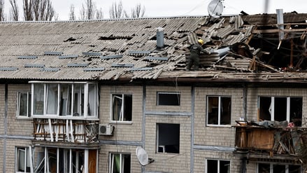 An emergency responder works at the site of a Russian drone strike on an apartment building, amid Russia’s attack on Ukraine, in Kyiv, Ukraine December 23, 2025. REUTERS/Thomas Peter