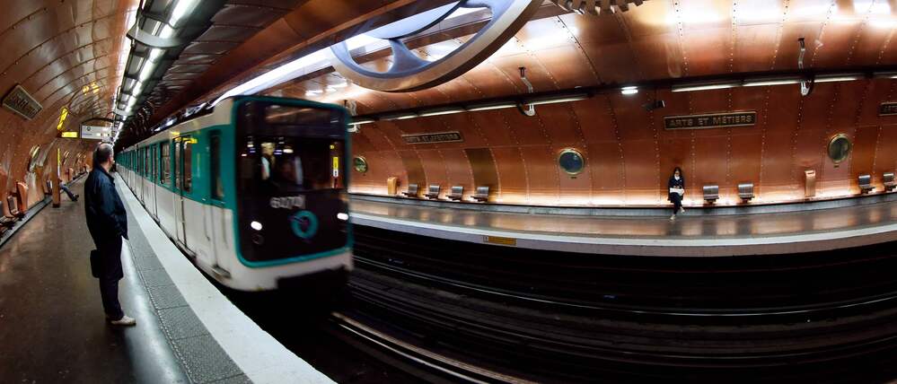 (FILES) This photograph shows a train arriving at the 'Arts et Metiers' metro station in Paris on November 28, 2012. Three women were stabbed and wounded at three different Paris Metro stations, including Opera, Arts et Metiers and Republique, on December 26, 2025, by an attacker who is still at large said the RATP, the body that runs the network. (Photo by PATRICK KOVARIK / AFP)