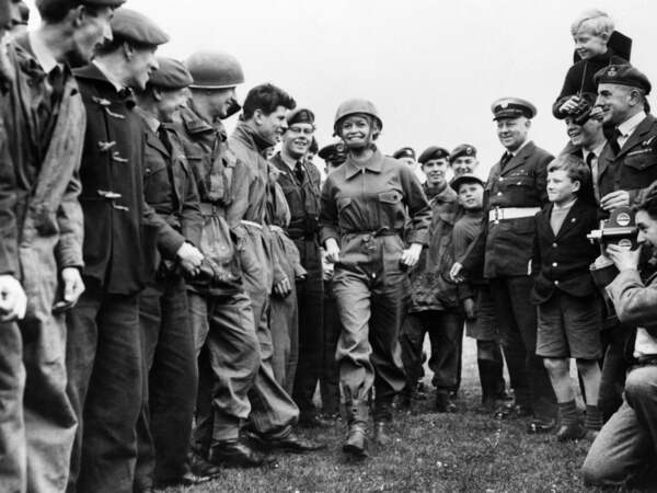(FILES) French actress Brigitte Bardot, in parachutist's equipment, walks among Royal Air Force boys, who have cancelled their leave, during the shooting of "Babette goes to war", directed by Christian-Jaque, on April 11, 1959 at RAF station Abingdon. French actress Brigitte Bardot died at 91 AFP learned from Bardot foundation on December 28, 2025. (Photo by INTERCONTINENTALE / AFP)