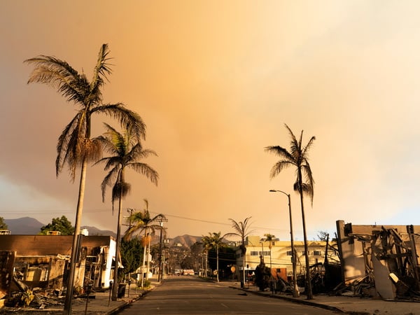 Smoke from the Palisades Fire rises above the remains of buildings in the Pacific Palisades neighborhood in Los Angeles, California, U.S. January 11, 2025. REUTERS/David Ryder