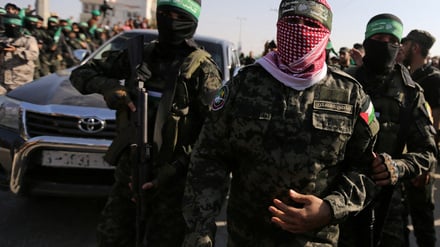 FILE PHOTO: Abu Ubaida, the spokesman of the Izz el-Deen al-Qassam Brigades, walks during an anti-Israel military show by Hamas militants in the southern Gaza Strip November 11, 2019. REUTERS/Ibraheem Abu Mustafa/File Photo