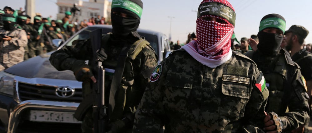FILE PHOTO: Abu Ubaida, the spokesman of the Izz el-Deen al-Qassam Brigades, walks during an anti-Israel military show by Hamas militants in the southern Gaza Strip November 11, 2019. REUTERS/Ibraheem Abu Mustafa/File Photo