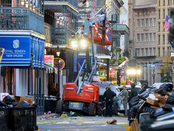Police investigators surround a white truck that has been crashed into a work lift in the French Quarter of New Orleans, Louisiana, on January 1, 2025. At least 10 people were killed and 30 injured Wednesday when a vehicle plowed overnight into a New year's crowd in the heart of the thriving New Orleans tourist district, authorities in the southern US city said. (Photo by Matthew HINTON / AFP)